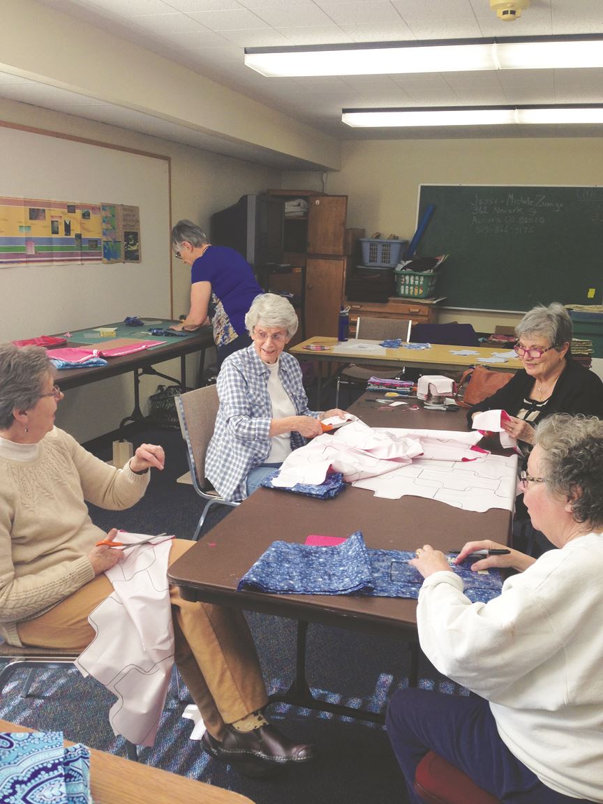 Heart of Longmont United Methodist Women making pads for girls