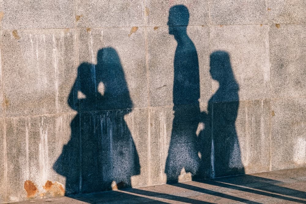 family shadow on concrete wall