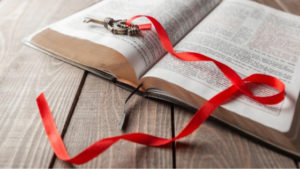 hymn book with key and red ribbon