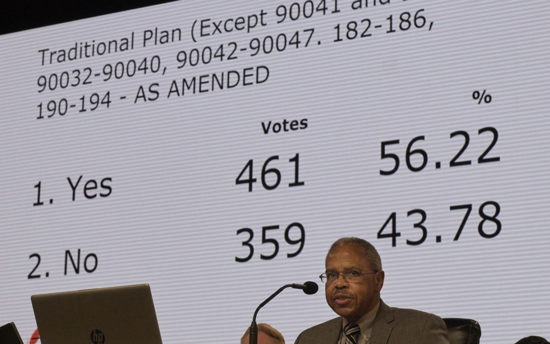 As the Rev. Joe Harris presides over the legislative committee, the results of a vote approving the Traditional Plan as amended by 461-359 are displayed. The vote must still be approved by the plenary session on Feb. 26, the final day of the special session of the 2019 General Conference of The United Methodist Church in St. Louis. Photo by Paul Jeffrey, UMNS.