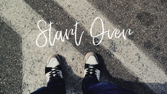 A person's feet on a starting line with the text "Start Over"