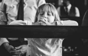 child praying in church