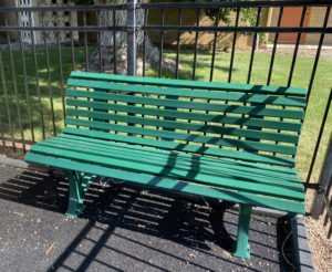 An image of the new green bench in the Heart of Longmont playground, courtesy of the 150th Celebration committee.