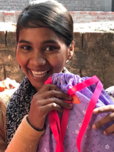 Photo of a young woman with a Days for Girls kit. Image used courtesy of Days for Girls.