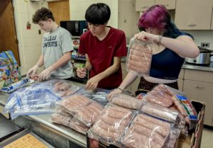 HOL BASIC youth preparing Chef Hearty bags for Wild Plum families