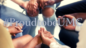 a diverse group of people holding hands in prayer with text that reads #ProudtobeUMC 