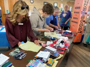 volunteers putting together Days for Girls menstrual hygiene kits