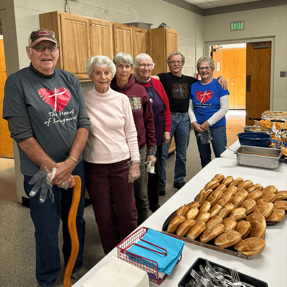 Volunteers lined up to serve a meal to HOPE clients